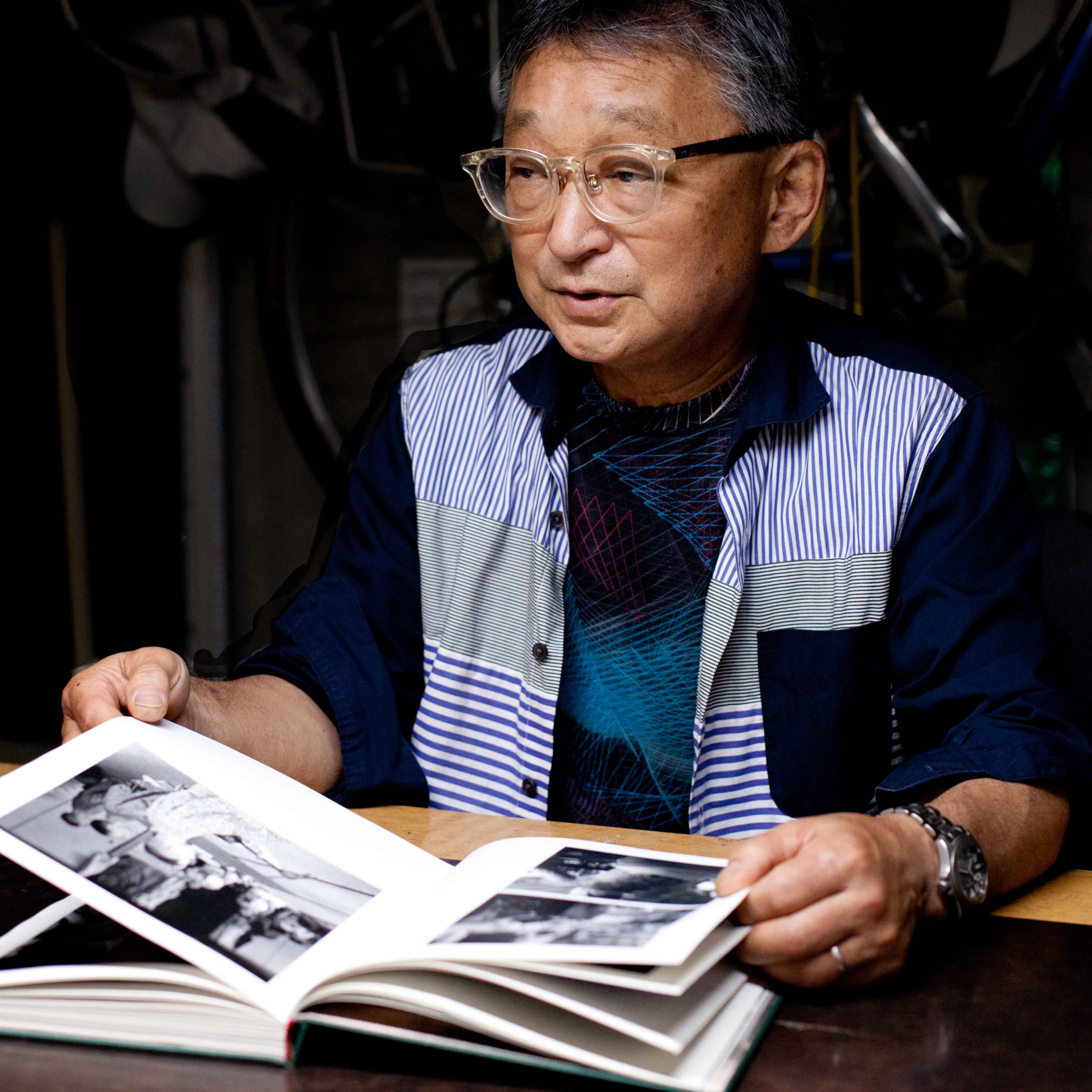 Japanese photographer Masato Sudo looking at the tattoo writer book in Tokyo, 2023